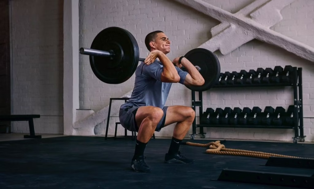 Uomo che si allena con i pesi in palestra